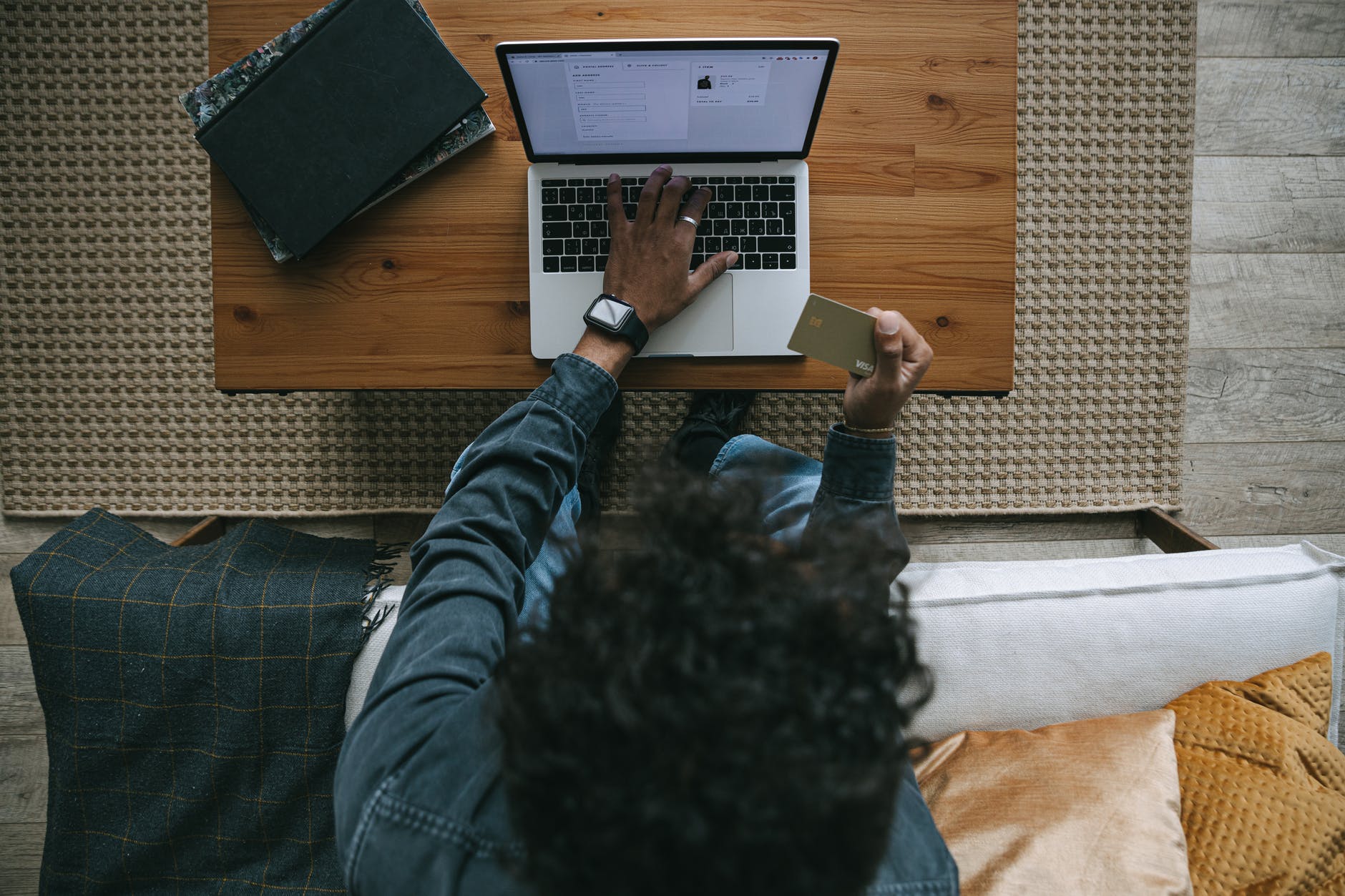 man in blue and black plaid dress shirt using macbook pro